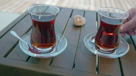 Two glasses of turkish tea on the table with wooden table on the background in Stock Footage 53133365