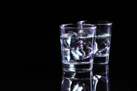 Two glasses of vodka with ice cubes Stock Photos
