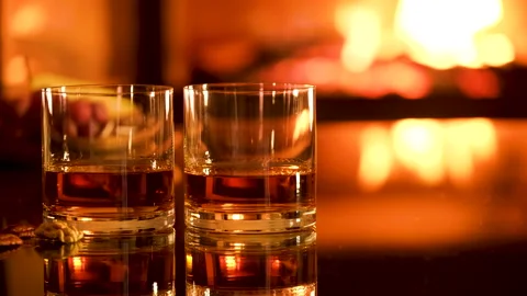 Two glasses with whiskey and serving on the fireplace background. Stock Footage 166393527