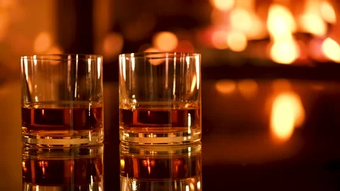 Two glasses with whiskey and serving on the  fireplace background. Stock Footage 166393581