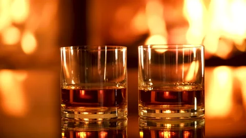 Two glasses with whiskey on the fireplace background. Stock Footage 166393907