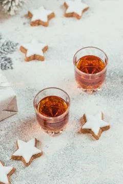 Two glasses of whiskey or bourbon, star cookies and decoration on white backg Stock Photos