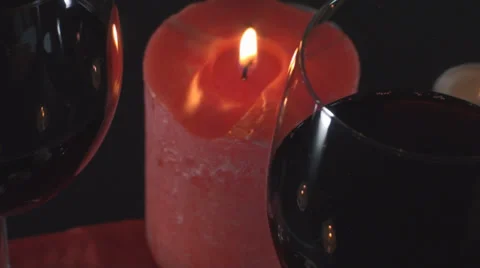 Two Glasses Of Wine And A Burning Candle In Background Stock Footage 34470228