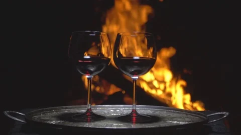Two glasses of wine on the background of fire Stock Footage 79750886
