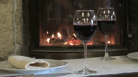 Two glasses of wine on the background of the fireplace Video stock 81677789