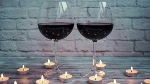 Two glasses of wine in candle ring Stock Footage 142685028