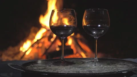 Two glasses of wine on fire background, dolly shot Stock Footage 96485462