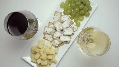 Two glasses of wine, red and white, with snacks. Top view Stock-Footage 73770869