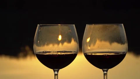 Two glasses of wine at sunset on a forest lake Stock Footage 139810031