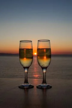 Two glasses of wine at sunset on the table Stock Photos