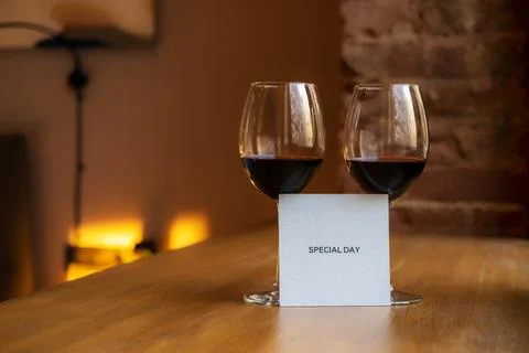 Two glasses of wine on the window. Stock Photos