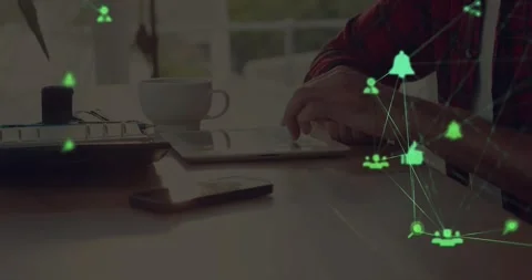 Two globes of digital icons spinning against mid section of a man using digital Stock Footage 328648110