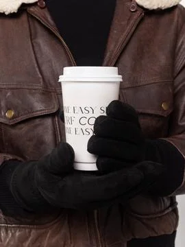 Two gloved hands holding coffee cup Stock Photos