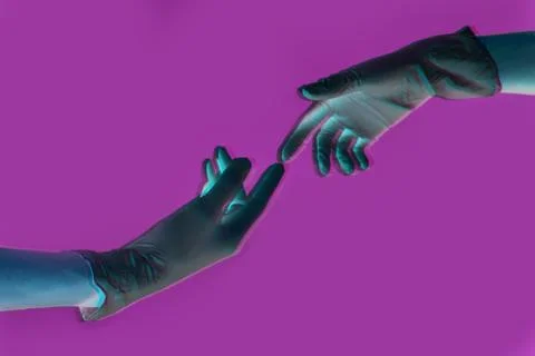 Two gloved hands touch each other on a lilac background. protected sex concept Stock Photos