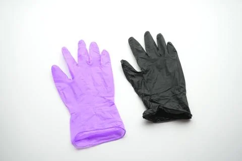 Two gloves of different colors on a white background. Medical gloves, latex Stock Photos