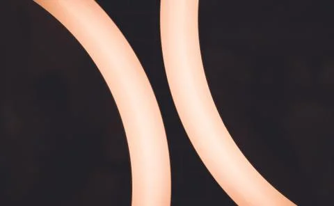 Two glowing halves of a ring on a dark background Stock Photos