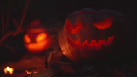 Two glowing pumpkin heads in night gloomy wizard autumn forest outside Halloween Stock Footage 139202280