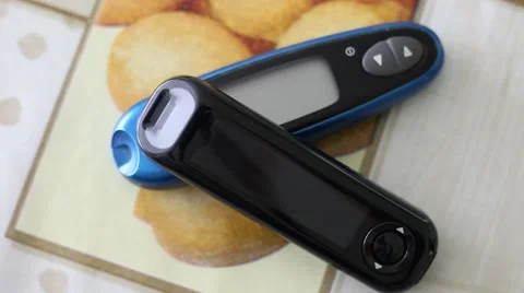 Two Glucose Meters Lying on a Table Stock Footage 67459665