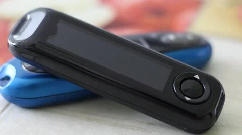 Two Glucose Meters Lying on a Table Video stock 67472094