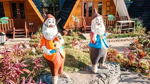 Two gnomes are standing in front of a house Stock Photos
