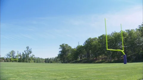 Two goalposts on the green NFL field on a sunny day Stock Footage 113275841