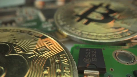 Two gold Bitcoin on the micro chip. Macro shot. Finance concept. Investment in Stock Footage 141713606