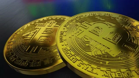 Two gold coins in the form of bitcoin on a dark table Stock Footage 147103292