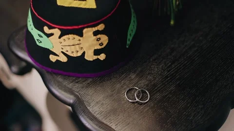 Two gold rings are lying on a wooden table. Close-up shooting Stock Footage 267742145