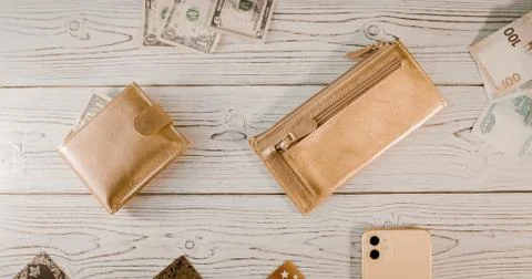 Two gold wallets, plastic cards, dollars, rubles, an expensive smartphone with Fotos de archivo