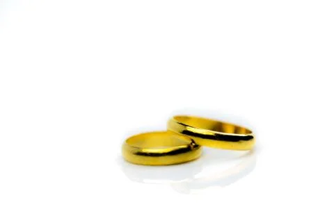Two gold wedding ring isolated on white background with copy space, just add  스톡 사진