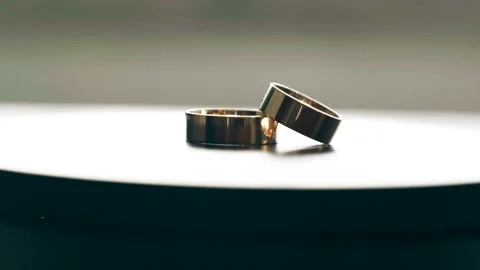 Two gold wedding rings rotate on the tab... | Stock Video | Pond5
