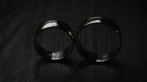 Two gold wedding rings shining with light close up macro.Transfusion of the Stock Footage 149116408