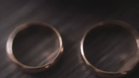 Two Gold Wedding Rings on the Table Stock Footage 62772239