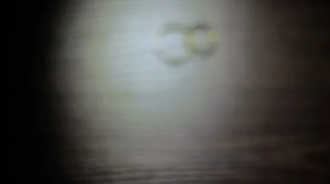 Two Gold Wedding Rings on the Table Stock Footage 68285423