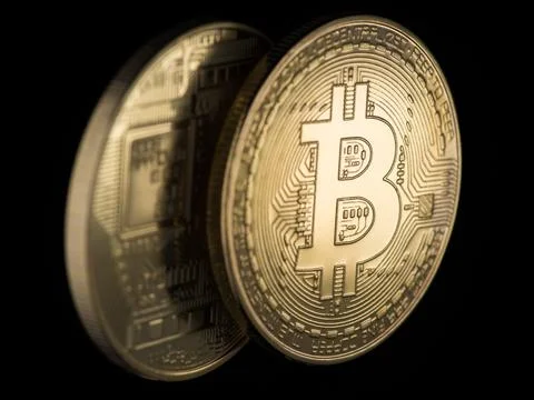 Two Golden bitcoins on a black background, closeup. electronic money Stock Photos