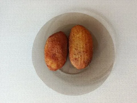 Two golden-brown breaded cutlets, possibly chicken Stock-Fotos