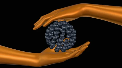Two golden human hands holding sphere from particles Stock Footage 180898595