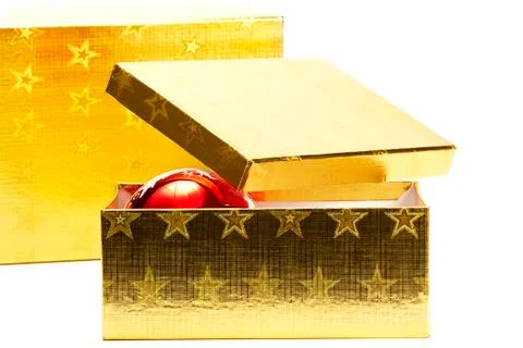 Two golden present boxes with one christmas ball Stock Photos