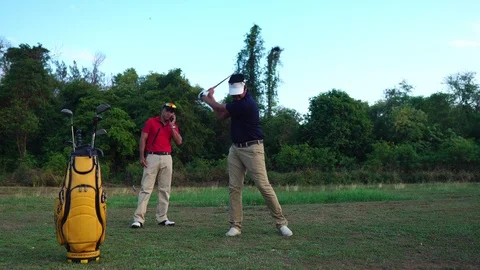 Two golfers are talking on the training ground  Stock Footage 129170454