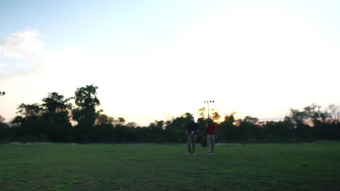 Two golfers are talking on the training ground  Stock Footage 129170932