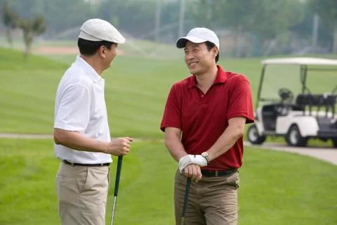 Two golfers chatting on the course Stock Photos