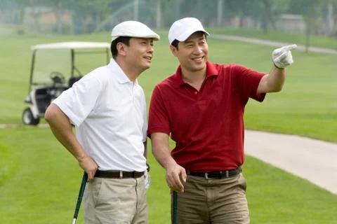 Two golfers chatting on the course Stock Photos