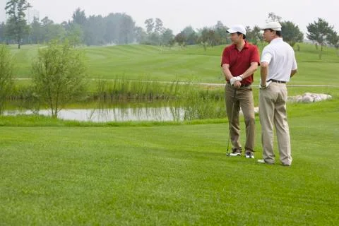 Two golfers chatting on the course Stock Photos