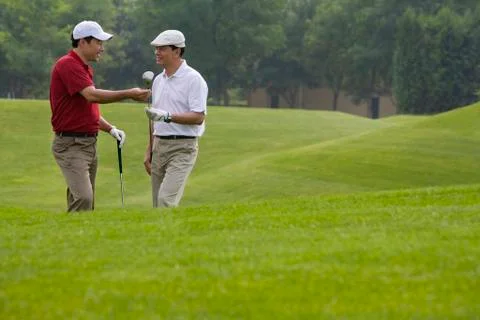 Two golfers chatting on the course Stock Photos