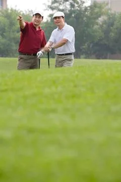 Two golfers chatting on the course Stock Photos