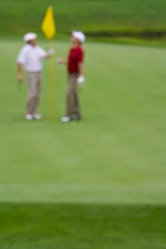 Two Golfers on the Green Stock Photos