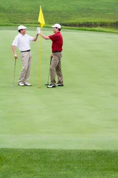 Two Golfers on the Green Stock Photos