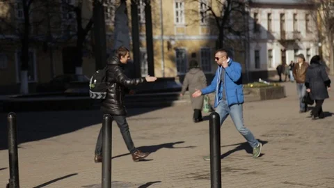 Two good guys are shaking hands and fists when meeting. Stock Footage 88155372