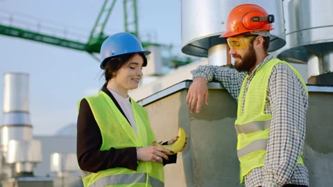 Two good looking divers specialists on the construction site at the break lady Stock Footage 143159112