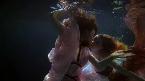 Two graceful nymphs of ocean or sea are swimming in deepness, romantic and Vídeo Stock 168368979